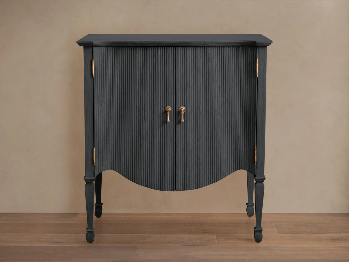 Conrad Hall Chest in Eclipse finish, blue with vertical ribbed texture, featuring two doors, bronze handles, on elegant curved legs.