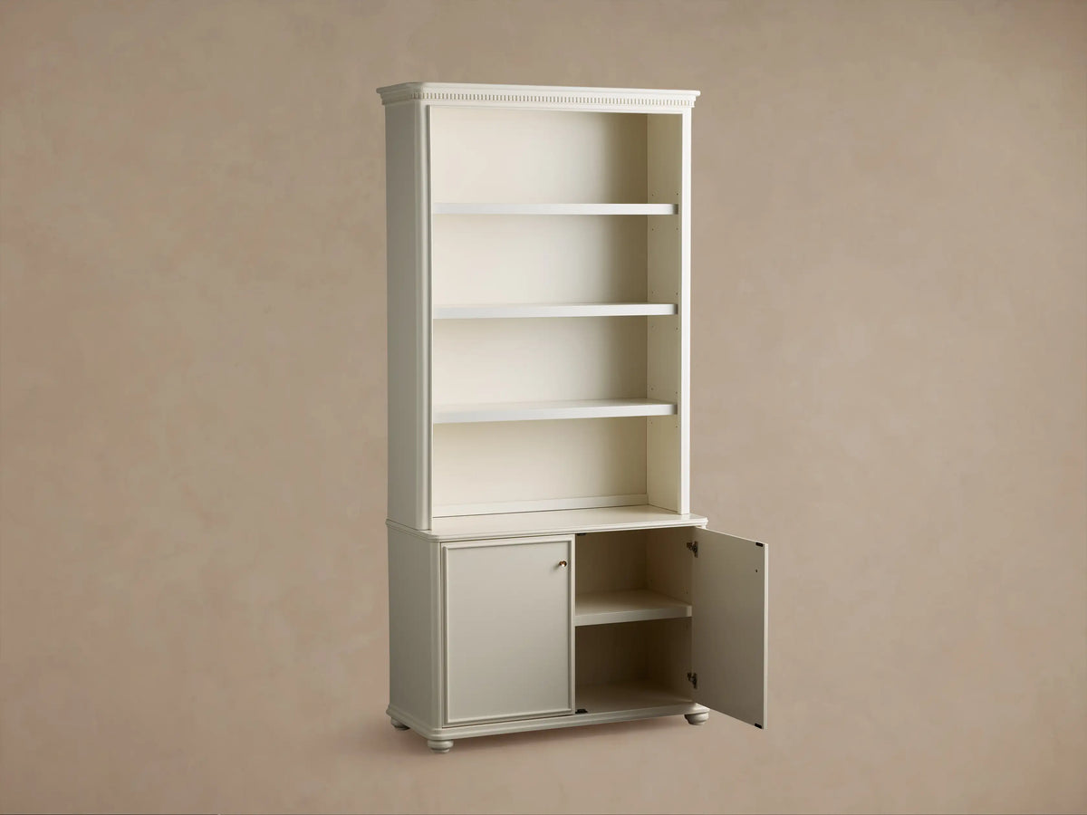 Partial view of a light gray Carlisle Hutch, showing open shelves, a counter, and cabinet doors with golden knobs.