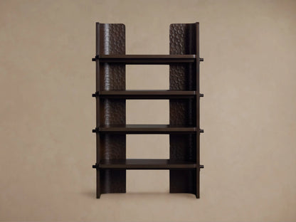 Dark brown chiseled bookcase made of handcrafted mahogany wood with four open shelves, standing against a beige wall.