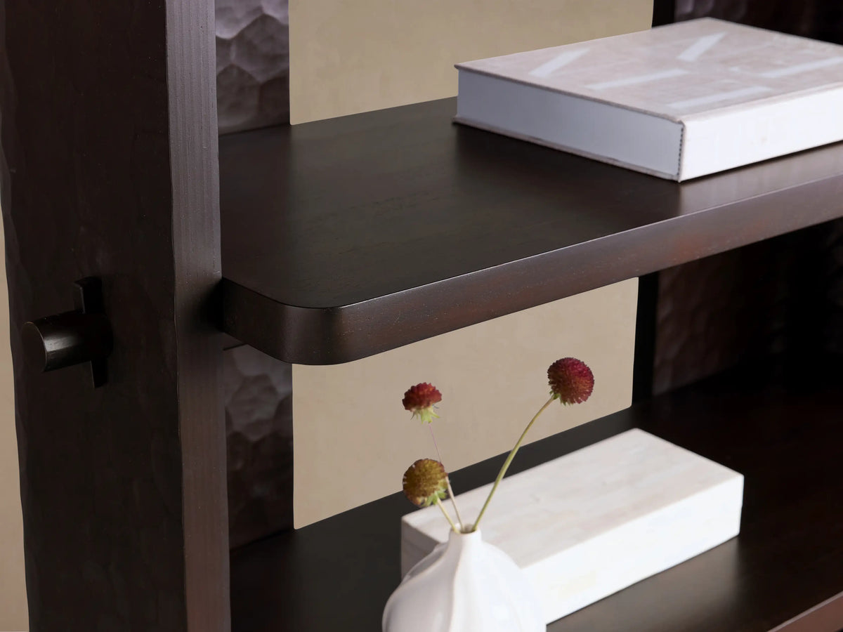 Dark brown Chiseled Bookcase with four open shelves. Front view, showing textured carved mahogany wood side panels.
