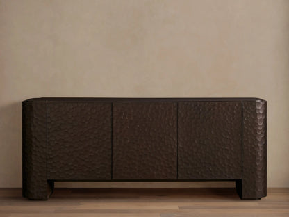 Dark brown Chiseled Sideboard with three textured doors, showcasing carved mahogany and a hand-applied finish on a wooden floor.
