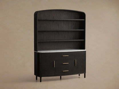 Front view of the black oak Danny Hutch with Drawers, featuring a white Carrara marble top, three brass-handled drawers, and two curved doors. Three open shelves are above.