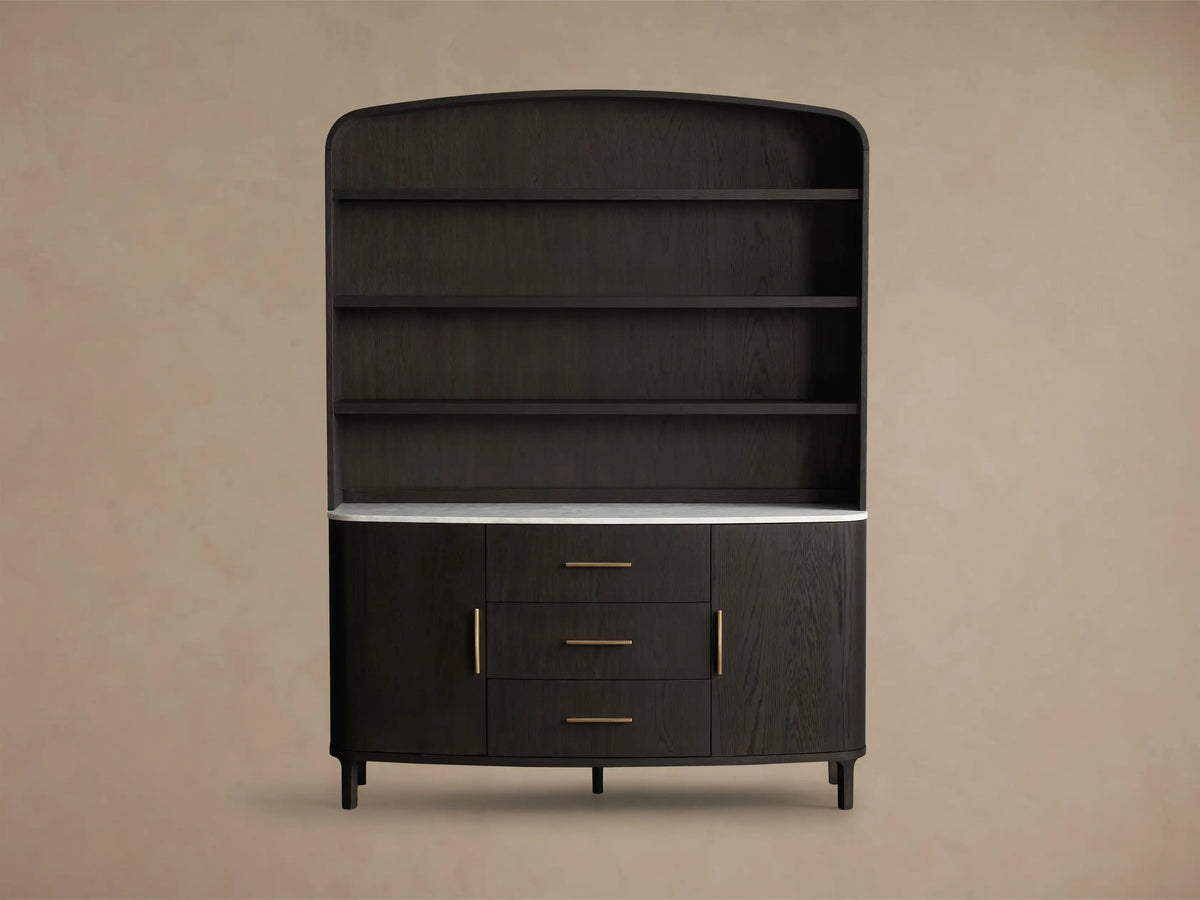 Close-up of dark oak Danny Hutch with Drawers. White Carrara marble top, gold handles, open cabinet revealing shelves.