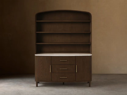 Front view of the dark oak Danny Hutch with Drawers, featuring a white marble countertop, three open shelves, three drawers with brass pulls, and two cabinet doors.