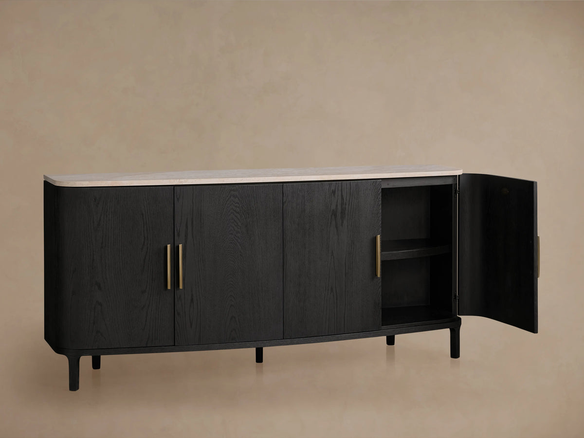 Danny Sideboard in ebony finish with white Carrara marble top, featuring brass-finished handles. One door open showing shelves.