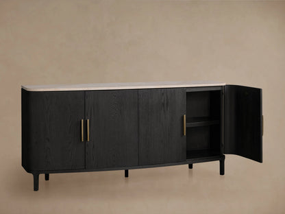 Danny Sideboard in ebony finish with white Carrara marble top, featuring brass-finished handles. One door open showing shelves.