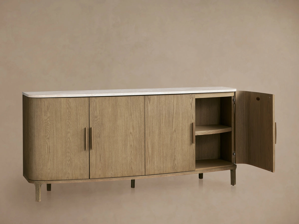 Danny Sideboard crafted from oak wood with a fawn finish, featuring a white marble top. Open door reveals two shelves, brass handles.