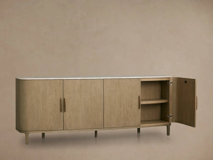 Danny Sideboard in fawn oak finish with white marble top. Open door reveals adjustable shelves and brass handles, on light legs.