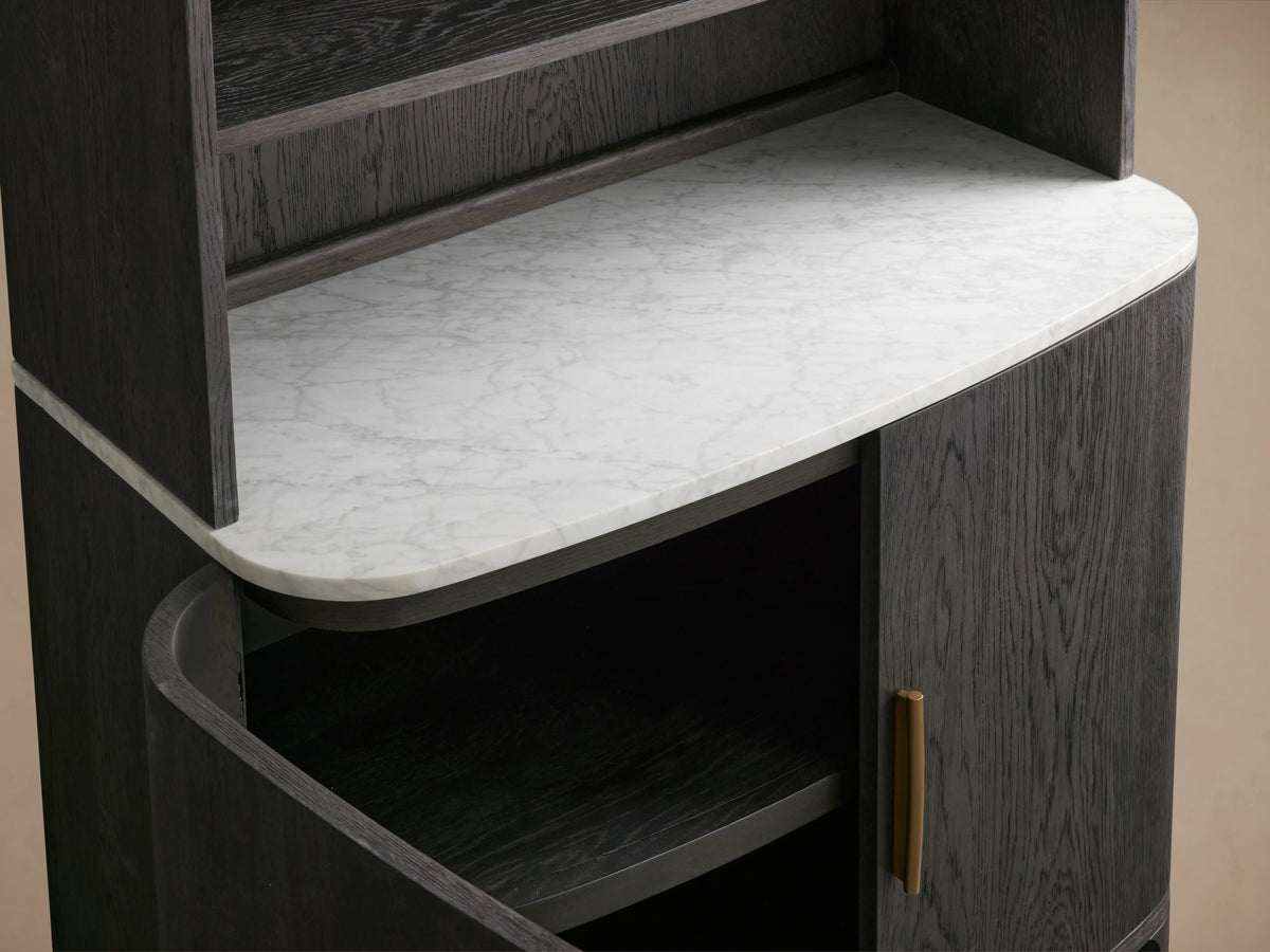 Danny Hutch shown with a dark ebony finish, featuring a white Carrara marble top. It has a gold handle and visible shelves.