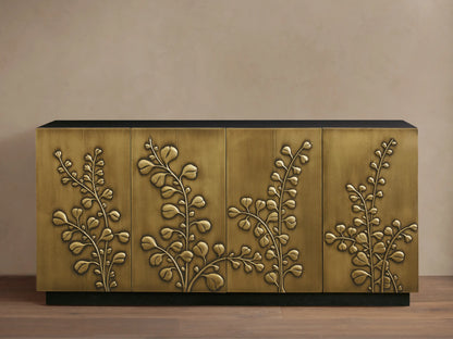 Etasha Sideboard: Brass finish cabinet with black top & base, detailed with intricate carved golden leaf designs on its four doors.