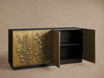 Etasha Sideboard close-up: partly open brass door with carved leaf design, dark ebony interior holding three clear wine glasses.