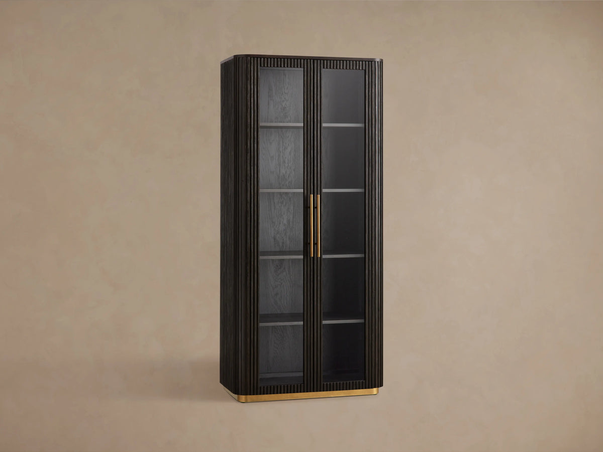 Finnley Glass Cabinet in a dark wood finish, featuring tempered glass doors with brass pulls, and a brass-accented base.