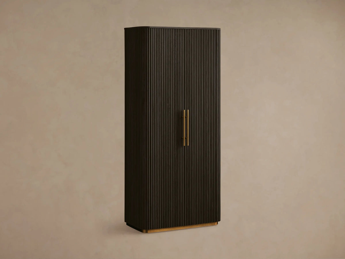 Dark Ebony Finnley Cabinet with fluted right door, brass pulls & plinth base. Left door open, shelves with decor visible.