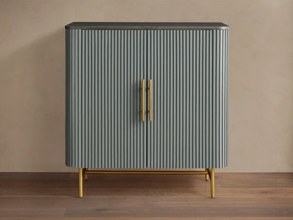 Finnley Bar Cabinet in pumice with vertical reeding detail, dark top, and gold brass-finished handles & legs.