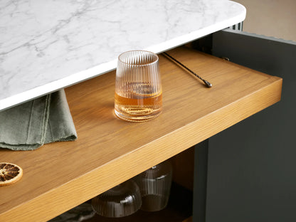 Finnley Bar Cabinet, gray fluted, white marble top, gold legs, right door open showing wine & glass storage.