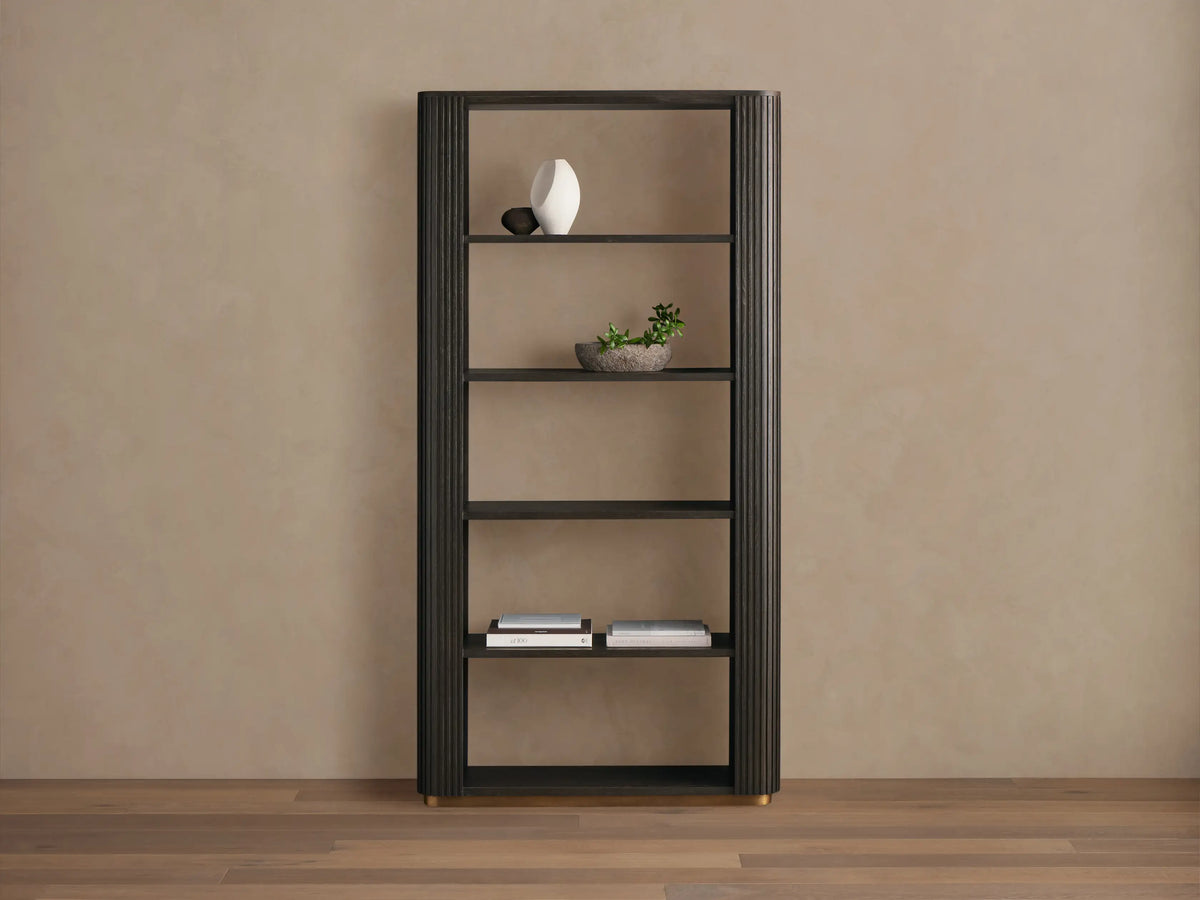 Finnley Bookcase, dark ebony oak veneer, with fluted sides, 5 open shelves displaying a vase, plant, and books, on brass feet.