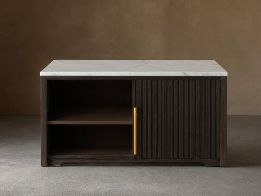 Close-up of the Finnley Sideboard's white marble top, dark reeded wood door, brass handle, and an open cabinet with an oak shelf.