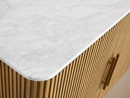 Finnley Plinth Sideboard with open fluted oak veneer cabinet, brass handles, marble top, showing interior shelves with wine glasses.