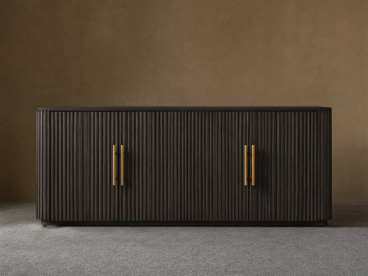 Finnley Wood Sideboard with ebony finish, ribbed surface, and brass-finished handles; set against a neutral background.