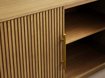 Finnley Wood Media Console in Honey finish with vertical slatted design, open door showing shelves, and brass hardware.