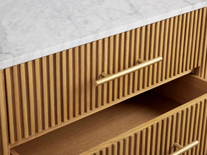 Finnley Sideboard with honey-colored wood finish, white marble top, open drawer and door showing shelves, brass hardware.