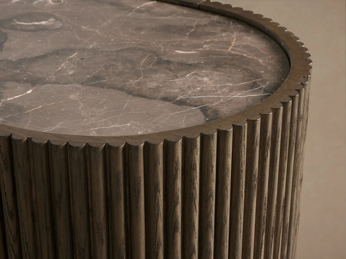 Flore Sideboard with reeded wooden detailing, curved edges, and a smooth stone top, set against a neutral background.