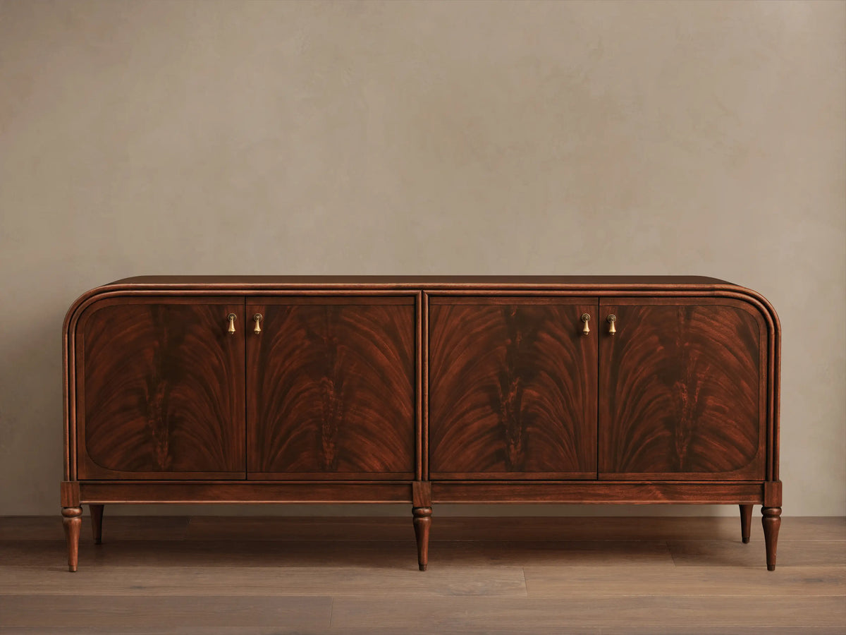 Frances Sideboard, dark mahogany with book-matched flame veneer on 4 doors, brass pulls, rounded corners, tapered legs.
