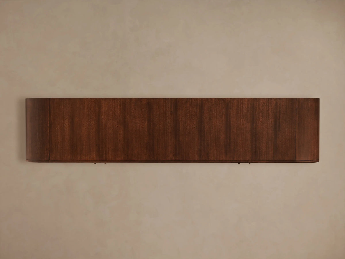 Frances Sideboard: Dark mahogany wood with figured veneer, vintage brass pull, and open cabinet with stacked white plates.