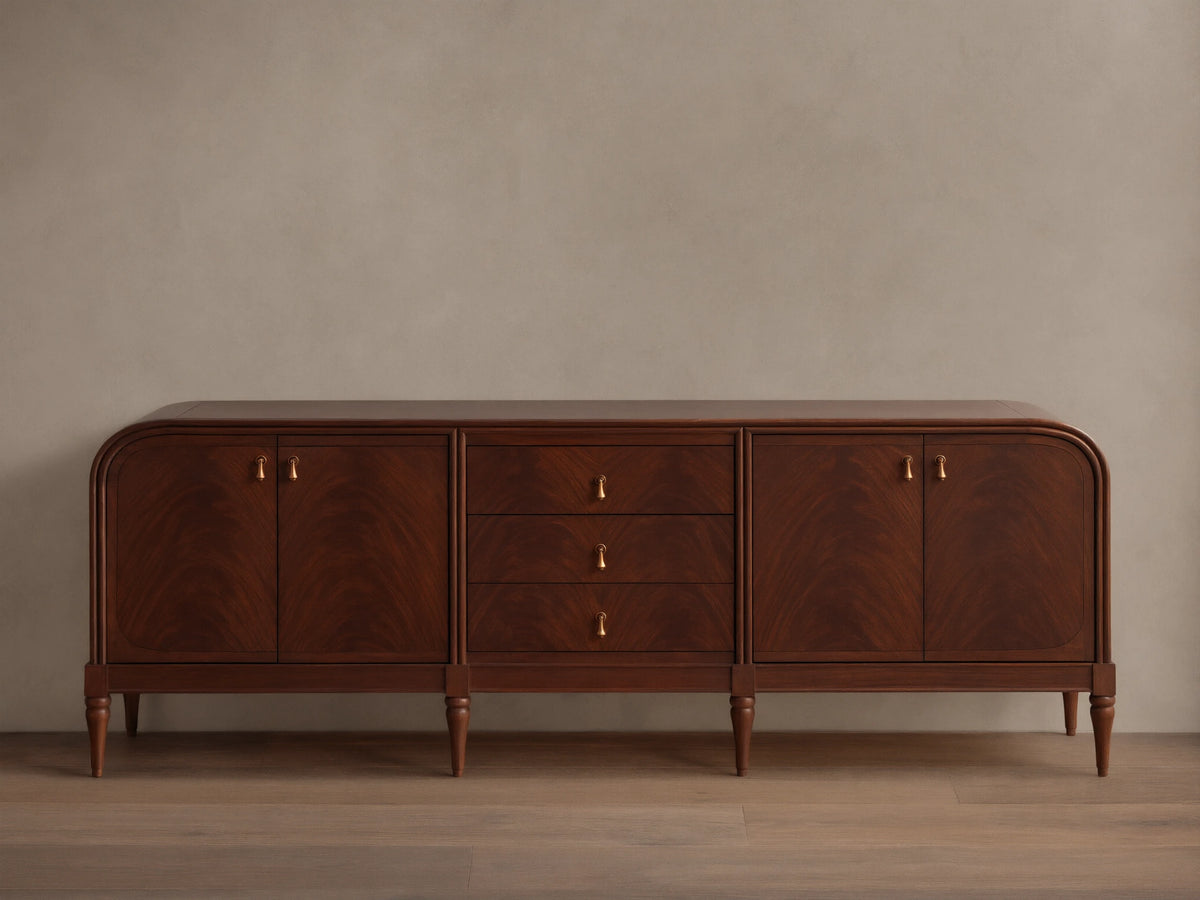 Front view of the Frances Sideboard with Drawers, featuring dark brown wood, rounded ends, three drawers, and brass pulls.