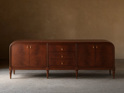 Front view of the Frances Sideboard with Drawers, featuring dark brown wood, rounded ends, three drawers, and brass pulls.
