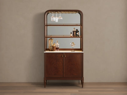 Front view of the Frances Bar Cabinet in dark mahogany with flame grain, brass stemware rack, marble top, and spirits.