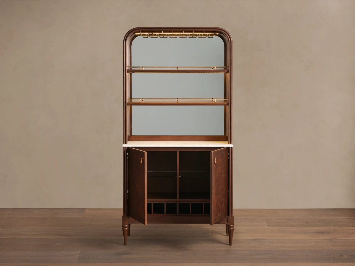 Front view of Frances Bar Cabinet. Mahogany, arched, brass stemware, mirrored, white marble, open doors, wine storage.