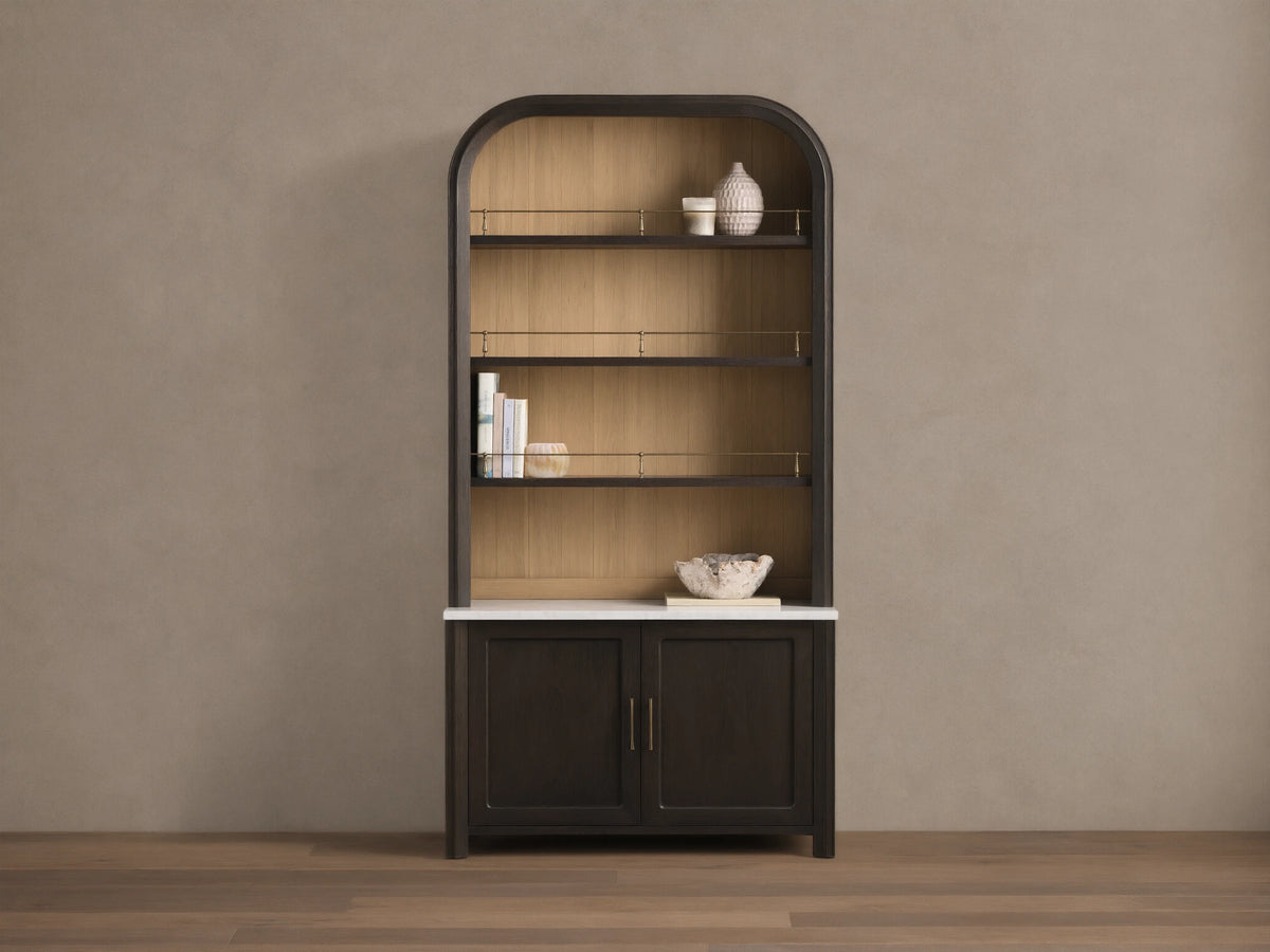 Front view of the Gatlin Hutch, a dark mocha wood hutch with an arched top, natural wood back panel, white marble, and brass accents.