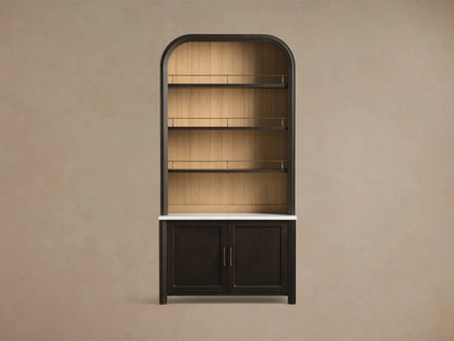 Front view of a mocha-toned Gatlin Hutch with an arched top, three shelves with antique brass rails, white marble top, and lower cabinet doors.