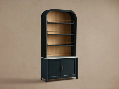 Front view of dark green Gatlin Hutch with rounded top, natural wood shelves, antique brass rails, white marble, wood doors.