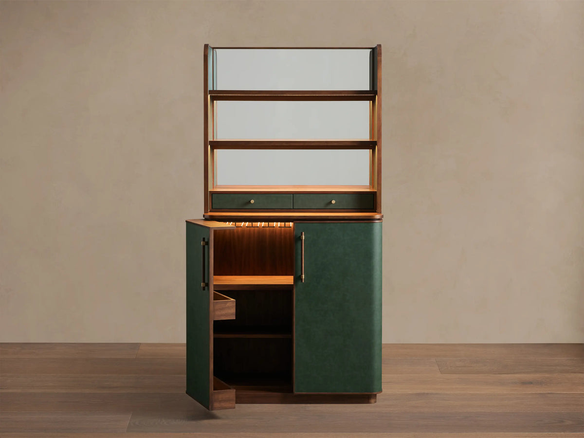 Front view of a Forest Green Grant Bar Cabinet, lower door open to reveal lighted walnut interior shelves.
