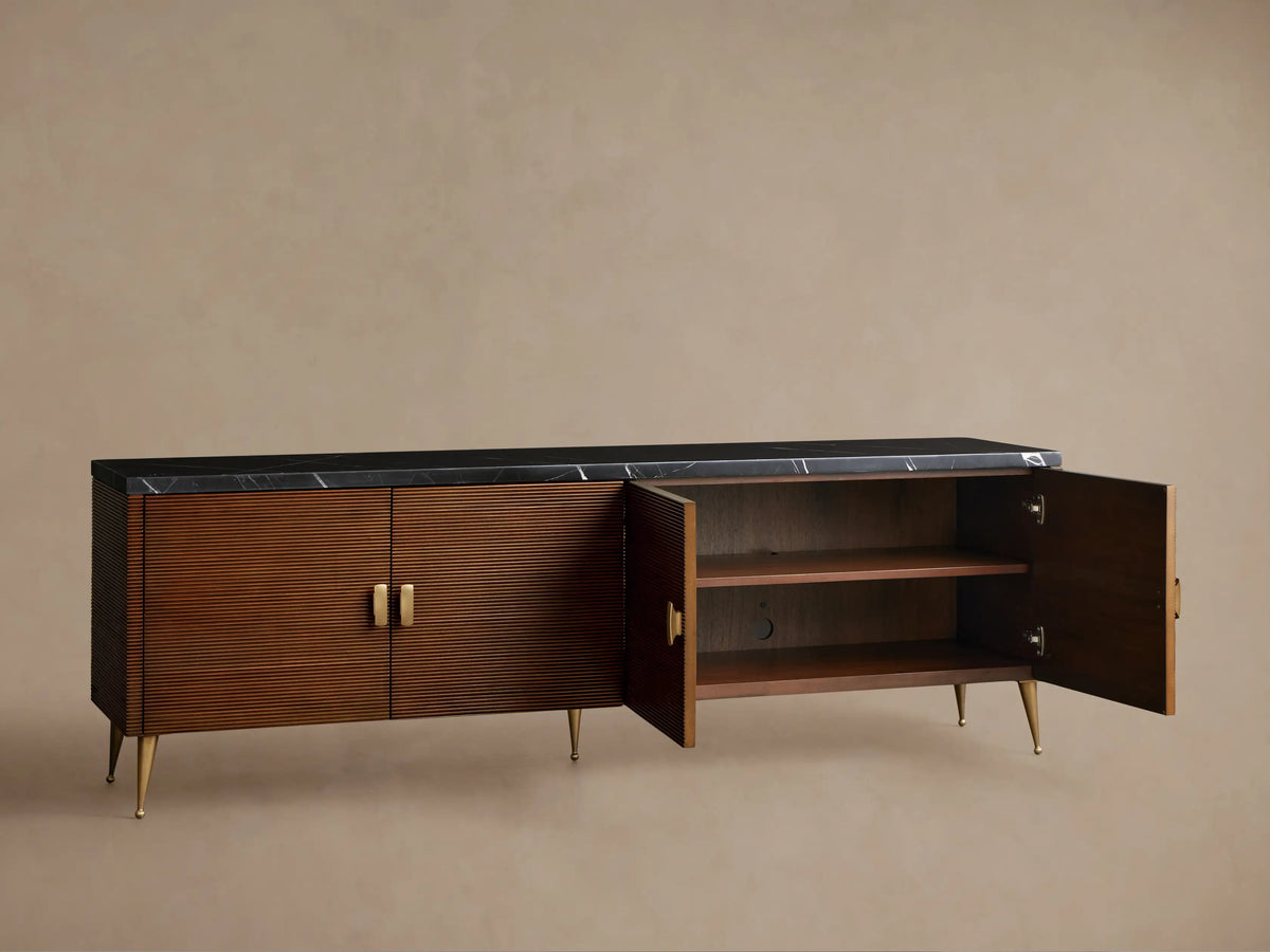 Giselle Media Console: mahogany wood cabinet with Nero Marquina marble top, four reeded doors, brass handles & tapered legs.