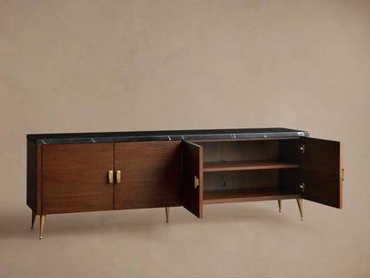 Giselle Media Console: mahogany wood cabinet with Nero Marquina marble top, four reeded doors, brass handles & tapered legs.