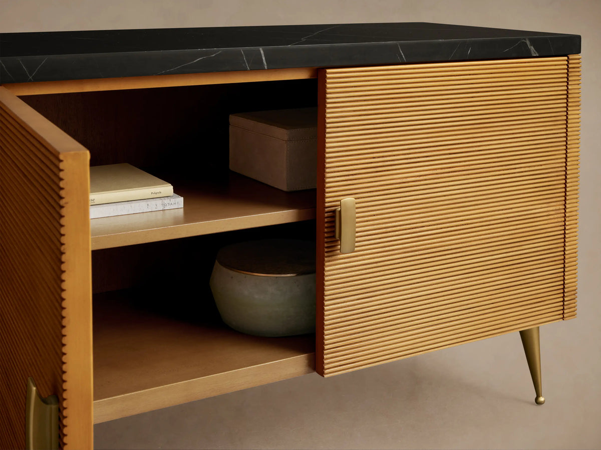 Giselle Media Console: dark mahogany with reeded doors, black marble top, brass handles & tapered legs. Right door open, showing shelves.