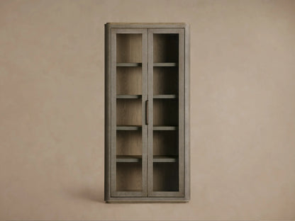 Front view of the light beige Cove Harrow Cabinet, a faux shagreen cabinet with two glass doors and champagne-brass handles.