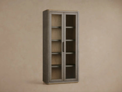 Close-up of Harrow Cabinet's dark faux shagreen door with bronze handle, revealing interior shelves and decorative items.