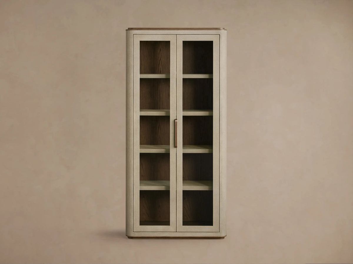 Front view of the Cove Harrow Cabinet, a tall rectangular cabinet with two glass doors, faux shagreen finish, and brass handles.