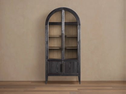 Front view of the Dark Hattie Glass Cabinet with an arched top, glass doors, light shiplap back panel, and reeded hardware.