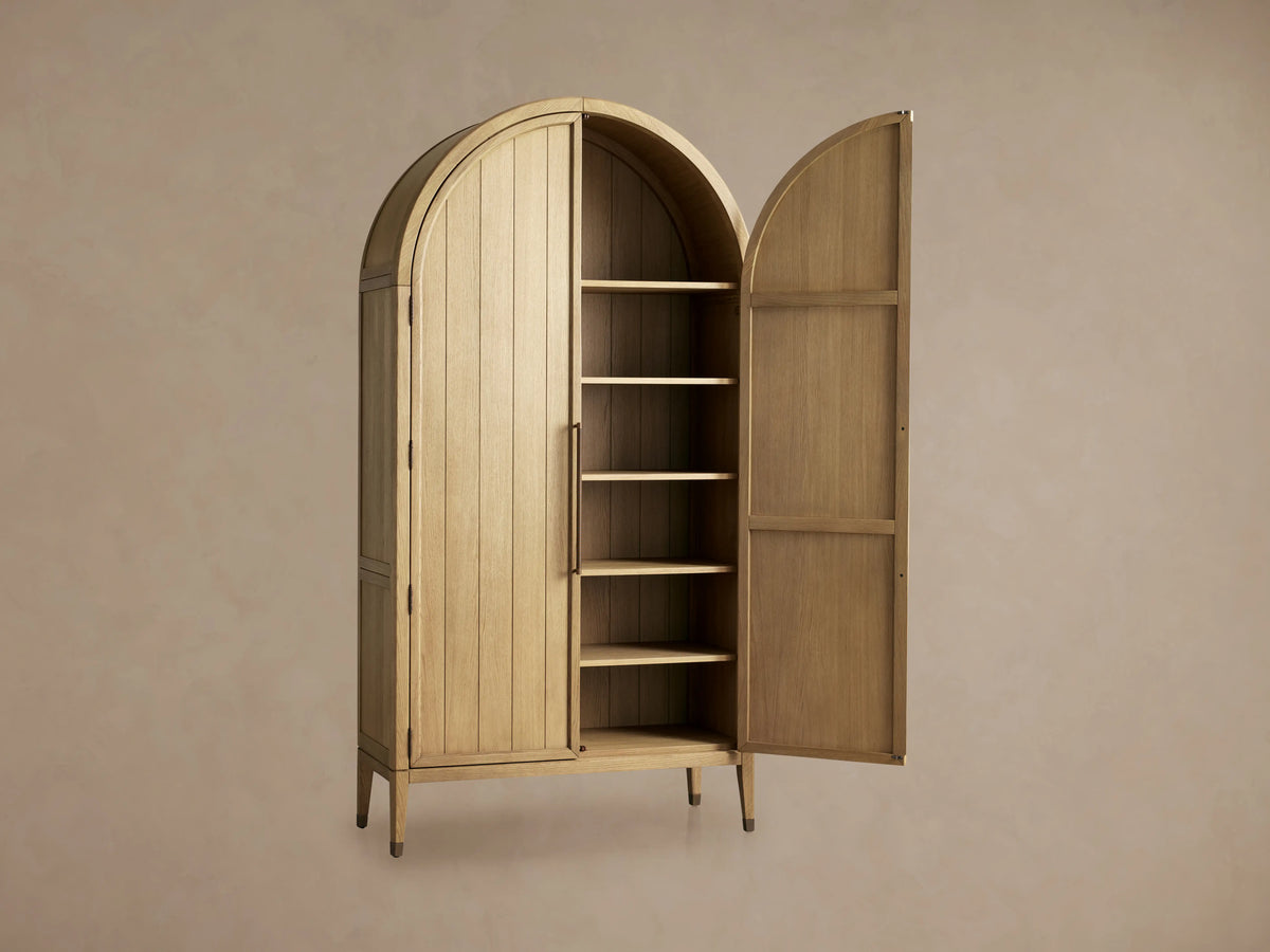 Hattie Cabinet close-up showing its solid oak wood with visible grain, adjustable shelves, and reeded hardware on the door.