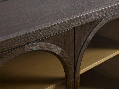 Hattie Media Console in dark oak with three arched doors, each revealing two shelves, against a beige wall. Shiplap back paneling visible.