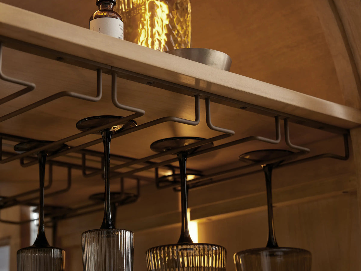 Hattie Burl Bar Cabinet close-up: light wood shelves with bowls, coasters, wine cubbies, and open burl wood veneer door.