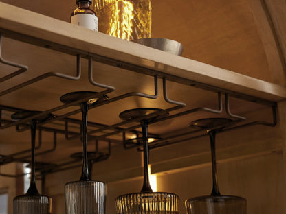Hattie Burl Bar Cabinet close-up: light wood shelves with bowls, coasters, wine cubbies, and open burl wood veneer door.