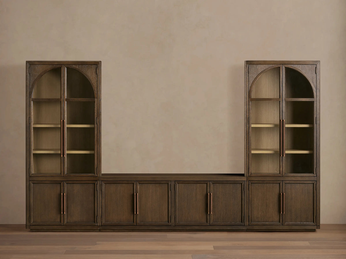 Hattie Glass Media Cabinet in dark oak. Upper glass doors show a vase; lower solid door is open, revealing a shelf & pink bowl.