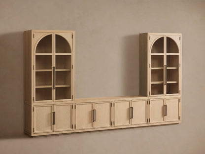 Light oak Hattie Glass Media Cabinet: two tall arched-top glass units with lower cabinets, flanking a low console, on wood floor.