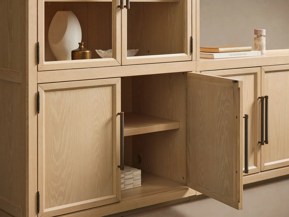 Hattie Glass Media Cabinet: Light oak wall-mounted system with arched glass doors on upper cabinets, solid lower doors, dark pulls.